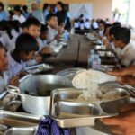 Officials and vendors at a food market highlighting healthy and affordable food reforms in Cambodia