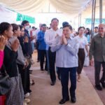 Heng Sour and Pursat officials meet with former migrant workers during employment announcement event.