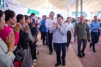Heng Sour and Pursat officials meet with former migrant workers during employment announcement event.