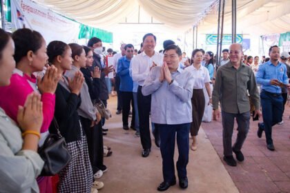 Heng Sour and Pursat officials meet with former migrant workers during employment announcement event.