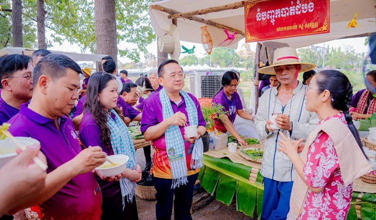 Tourists enjoying traditional Khmer food and cooking demonstrations at Battambang food festival