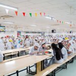 Cambodia fortified rice nutrition program for factory workers showing meal distribution in industrial zone