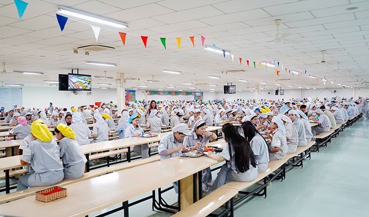 Cambodia fortified rice nutrition program for factory workers showing meal distribution in industrial zone