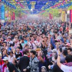 Tourists celebrating Khmer New Year in Kampong Cham Cambodia with large festive crowds and cultural activities