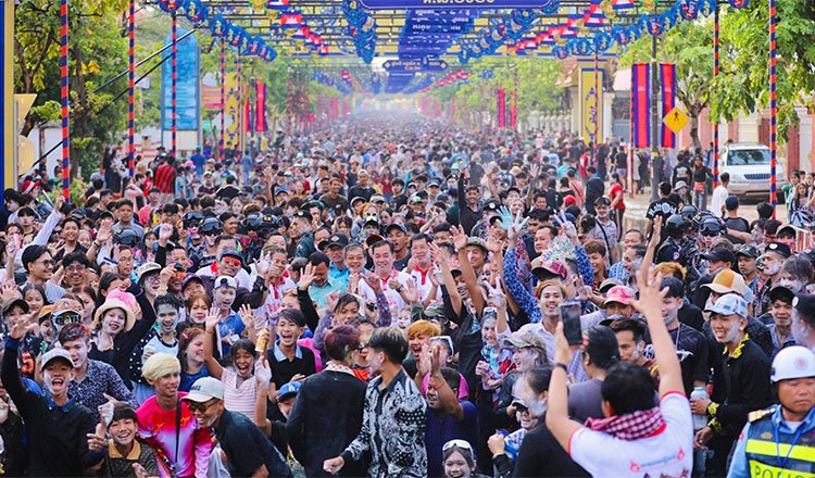 Tourists celebrating Khmer New Year in Kampong Cham Cambodia with large festive crowds and cultural activities